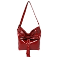 Chic red patent leather bucket bag featuring a large bow and silver stud accents - Red