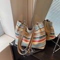 Colorful striped woven tote bag with brown leather straps and metallic chain detail - Colorful