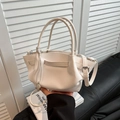 White bucket bag with lychee texture featuring dual handles and metal pendant - White