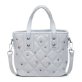 Light blue quilted bucket bag with rhinestones and metal studs, featuring a top handle - Blue