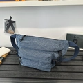 Dark blue washed denim crossbody chest bag with adjustable strap and front zipper pocket - Blue