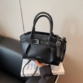 Elegant black lychee grain leather handbag with pleated design and silver metallic buckle - Black