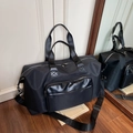 Large black travel bag made of water-resistant nylon with leather stitching and shoulder strap - Black
