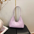 Macro detail of lavender crocodile embossed faux leather on a minimalist hobo handbag - Vintage Purple
