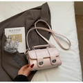 Borsa a mano cilindrica rosa chiaro lucida con chiusure rotanti argentate e tracolla - Senza ciondolo / Rosa
