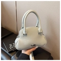 Detail view of mint green lychee grain leather shell bag with circular handles - White