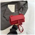 Detail of red lychee textured leather crossbody bag with white contrast stitching - Red