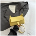 Detailed view of yellow lychee texture leather handbag on stylish minimal background - Yellow