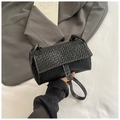 Detail of black woven shoulder bag with white contrast stitching and minimalist flap - Black