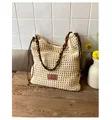 Detailed close-up of woven hollow-out pattern and leather brand label on the tote bag - Off White