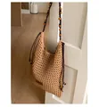 Close-up of hollow out woven tote bag with wooden bead shoulder strap and leather detail - Khaki