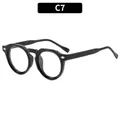 Lunettes de soleil rondes rétro noires avec rivets argentés et finition polie C7 - Monture Noire Verres Transparents