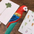 Handcrafted wooden macaw parrot pen with vibrant hand-painted colors and carved texture - Red Parrot