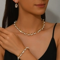 Close-up of bridal rhinestone jewelry set with white pearls on a model wearing black dress - 3-Piece Set(GT25252) / Gold White