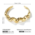 Macro detail of wave-textured gold stainless steel bangle showing size and weight info - Gold Streamlined Wave Style (STB-BC0067)