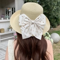 Beige woven straw sun hat featuring a large cream bow with brown heart print detail - Beige With Curled Edges And Large Butterfly Design