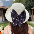 Beige woven straw sun hat for women featuring a large black bow with white heart patterns - Curled-up Large Butterfly Milky White