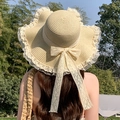 Beige woven straw sun hat with wavy lace brim and large ribbon bow for summer beach travel - Wave Lace Edge Beige