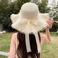 Straw sun hat in light beige featuring a large lace bow and wavy brim for women - Wavy Edge Milky White
