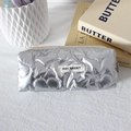 Detailed view of silver quilted heart texture on waterproof PU makeup bag with zipper - Large Heart Silver