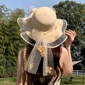 Women's beige wide brim straw sun hat featuring a large yellow bow and floral mesh ribbon - Wave Eight Flowers Beige