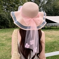 Pink sun hat with wide wavy brim and large bow, perfect for summer beach vacations - Waves And Pink