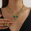 Green rhinestone necklace and earrings set with gold vine leaf design on model - 2-Piece Set(GT25268) / Gold Green