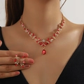 Elegant gold vine jewelry set with ruby red teardrop rhinestones on female model - 2-Piece Set(GT25277) / Red