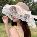 Light brown straw sun hat with white lace floral embroidery and wide wavy brim - Bridal Style Pink