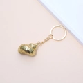 Golden conch shell keychain with metallic texture and spiral details on orange background - 24# (Red Brown Spotted Conch)
