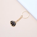 Golden keychain with a black enamel shell pendant and metallic striped textures - 32# (Yellow Radial Scallop)