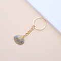 Golden seashell keychain with blue and purple striped glitter finish on cream background - 35# (Green Gold Radial Scallop)