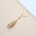 Golden striped conch shell keychain pendant with a polished metallic gold key ring - 55# (Gold Striped Conch)