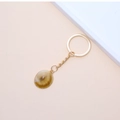 Golden keychain featuring natural shell pendant with brown gradient on neutral background - 58# (Brown White Gradient Pendant)