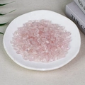 Natural pink rose quartz crystal chips displayed in a white ceramic dish for home decor - 100g Of High-quality Rose Quartz (7-9mm)