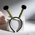 Detail of bee headband featuring yellow and black striped spring antennae with fluffy pom-poms - Black Ball & Black-Yellow Striped Antenna
