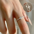 Delicate silver clover ring with sparkling zircons worn on finger close-up detail view - Open Adjustable / Matte Clover