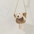 Detailed view of woven straw beach bag featuring a cute plush teddy bear and shoulder strap - Khaki (Bear with Blue Bow)