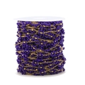 1.5mm golden stainless steel chain with dark purple faceted beads on a white spool - Sapphire Blue