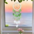 Handmade unicorn dream catcher with green seashell slices hanging by a seaside window - Finished Product / Rainbow Horse Summer-Green