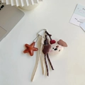 Plush dog and leather star charm keychain with woven strap in cream and brown - Charm / Apple