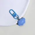 Macro shot of blue resin cloud keychain with matte pendant and matching lobster clasp - Blue