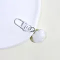 Close-up of white minimalist resin cloud keychain with matte finish and matching lobster clasp - White