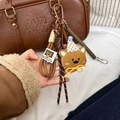 Brown plush bear keychain featuring a polka dot party hat and woven rope strap - Spring Rope Pendant / Brown Bear