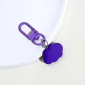 Detail of purple cloud pendant keychain with matte alloy clasp on white plate - Dark Purple