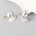 Macro view of silver geometric fan-shaped earrings with polished metallic texture - Silver