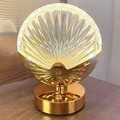 Shell shaped crystal night light with golden metal base and warm ambient lighting - Shell Style