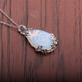 Water drop moonstone necklace with silver floral filigree detail on wooden background - Opal Water Drop (NSN0029)