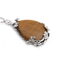 Macro detail of teardrop tiger eye gemstone pendant with silver floral hollow design - Tiger Eye Water Drop (NSN0025)