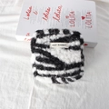 Close-up of zebra pattern plush storage bag with MAY RABBIT woven label detail - Zebra Stripe Sherpa